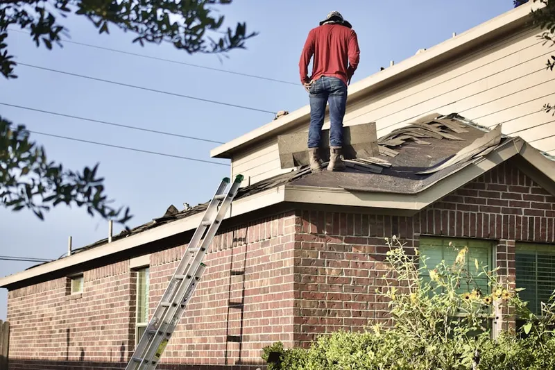 Professional roofer working on a residential roof in Calexico